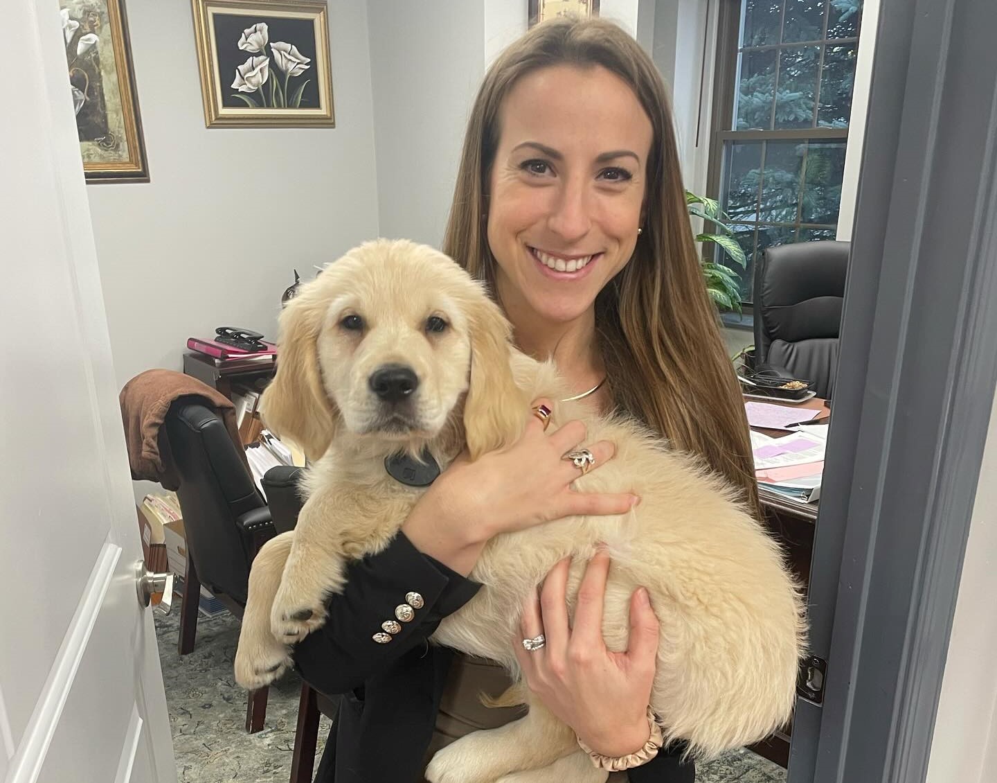 michael kuldiner law office's loretta golding attorney holding a puppy